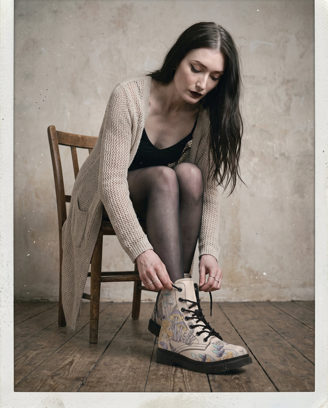 Model on a chair wearing Witching Spores Boots, studio