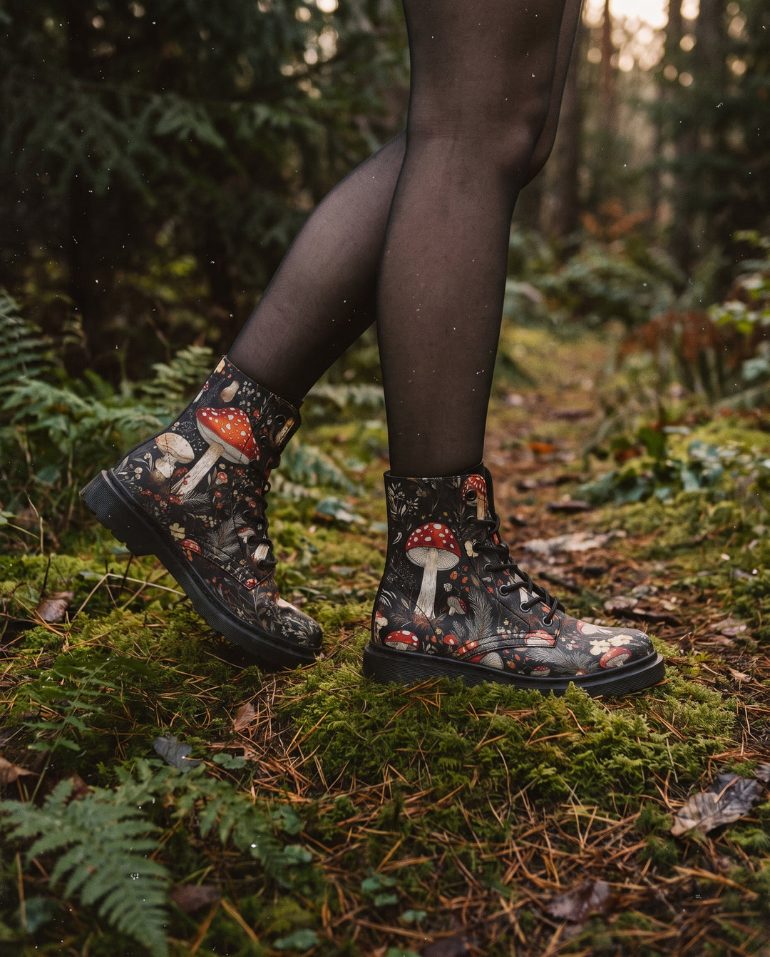 Legs in sheer black tights walking through a forest wearing Amanita Boots