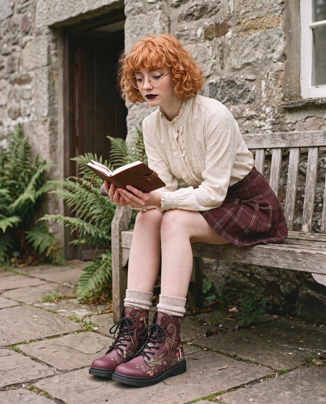 Fern Frenzy Boots with a tartan mini outside a stone cottage